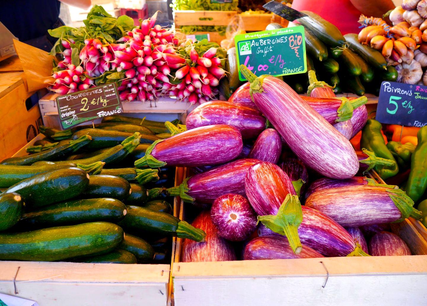 Striped aubergines, courgettes and radishes on a French market stall