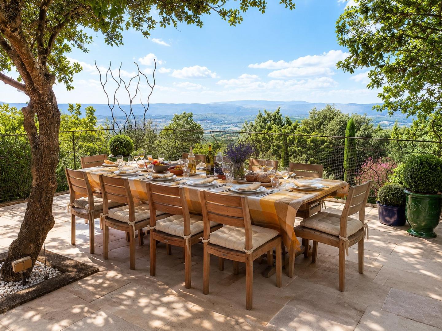Outdoor dining terrace at Villa Bonnieux looking over the Luberon valley